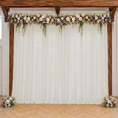 Rustic wedding backdrop with white drapes and blush floral arch
