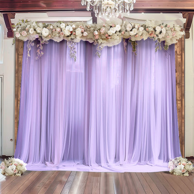 Lavender drapery backdrop with floral accents for events and photography.