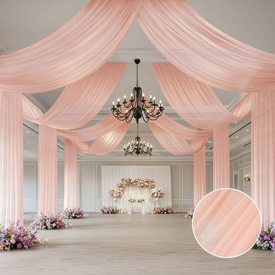 Elegant pink drapery in a beautifully decorated event space with floral arrangements.