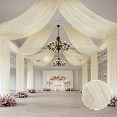 Elegant draped fabric decor for event spaces with floral arrangements.