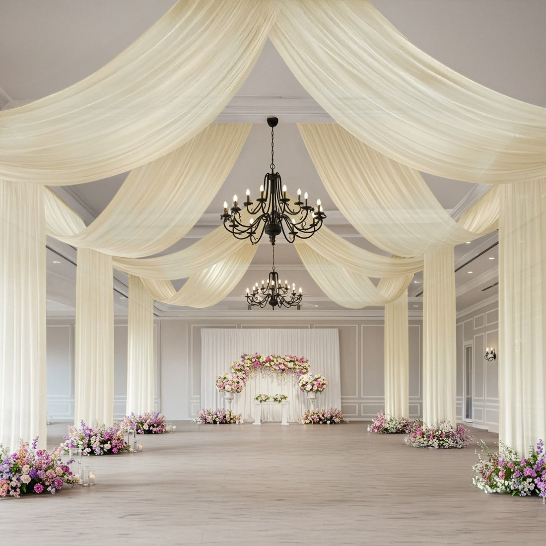 Elegant wedding venue with draped fabric and floral arrangements.