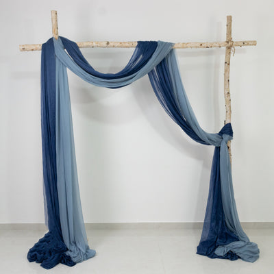 Blue and gray draped fabric backdrop on a wooden frame for photography.