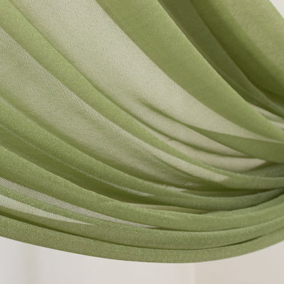 Green sheer fabric draped elegantly, showcasing its soft texture and flow.