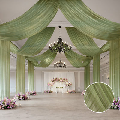 Elegant green drapery in a beautifully decorated event space with floral arrangements.