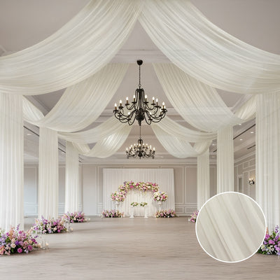 Elegant white drapery and chandelier in a decorated event space.
