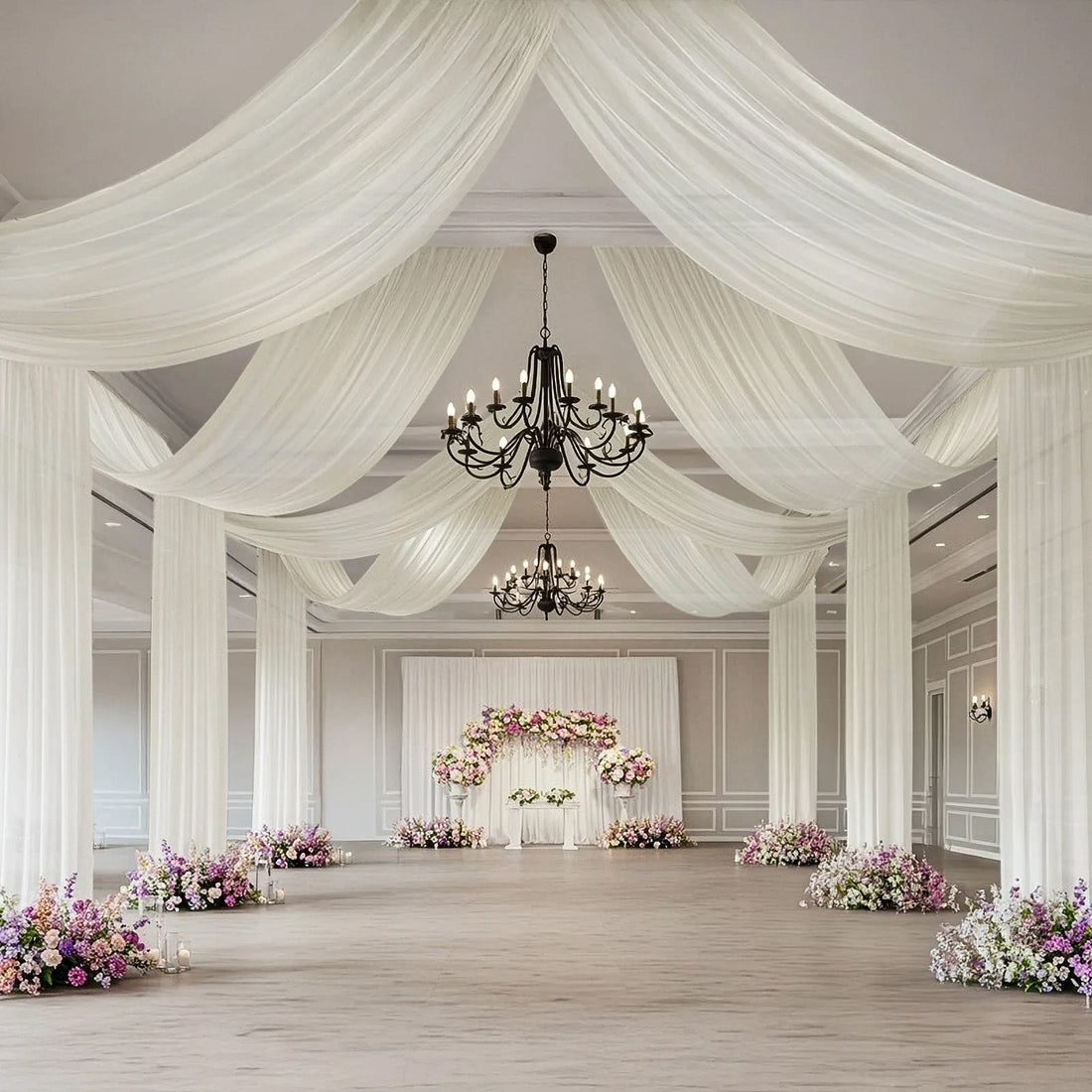 Elegant wedding venue with draped fabric and floral arrangements.