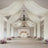 Elegant wedding venue with draped fabric and floral arrangements.