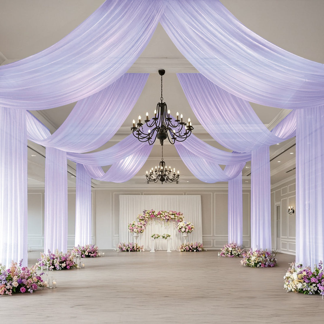 Elegant wedding venue with draped fabric and floral arrangements.
