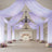Elegant wedding venue with draped fabric and floral arrangements.