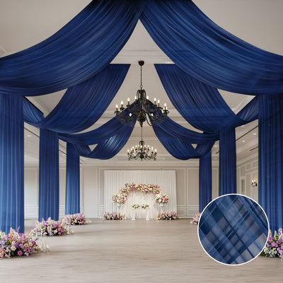 Elegant blue drapery in a spacious event venue with floral decorations.