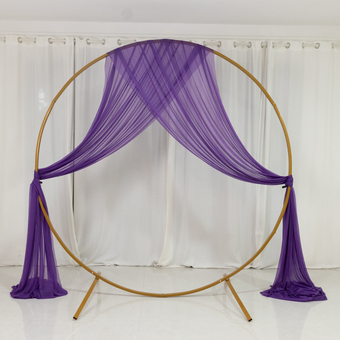 Purple drapery backdrop on a circular frame for events or photography.