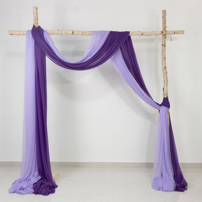 Purple and lavender fabric draped elegantly on a wooden frame.
