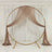 Gold circular backdrop stand with flowing brown drapery.