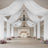 Elegant wedding venue with draped fabric and floral arrangements.