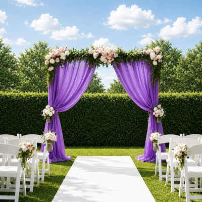 Purple wedding arch with floral drapery and white chairs in outdoor garden ceremony