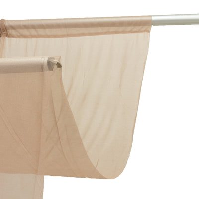 Beige sheer curtain draped on a silver curtain rod