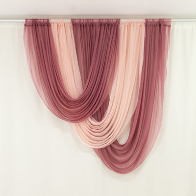 Sheer draped curtains in shades of burgundy and blush on a neutral background.