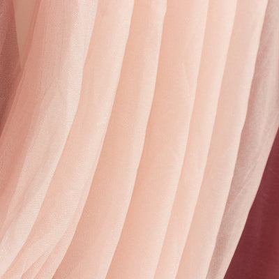 Soft pink tulle fabric draped in gentle layers.