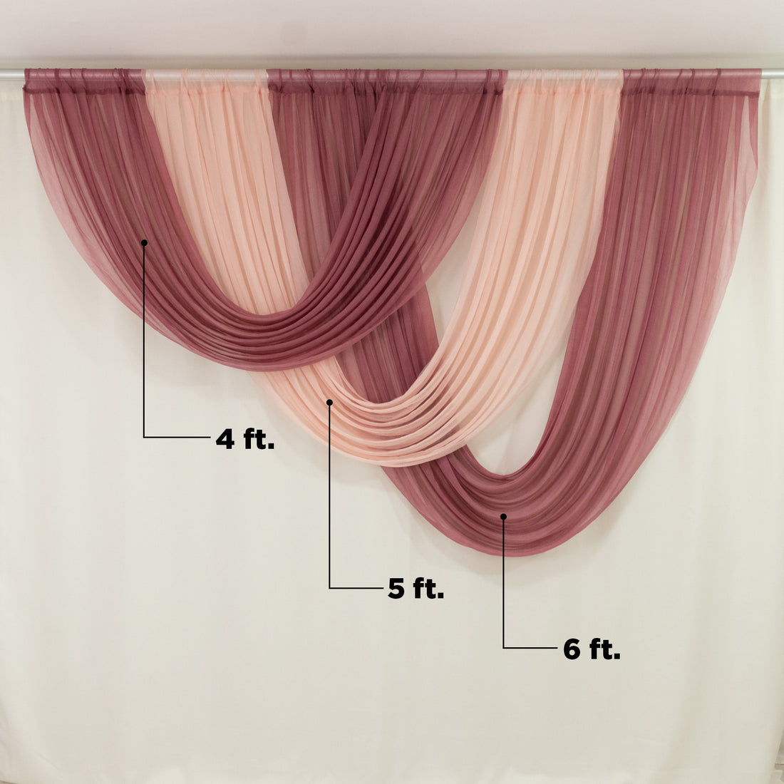 Sheer curtains in shades of pink and burgundy draped elegantly.