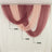 Sheer curtains in shades of pink and burgundy draped elegantly.