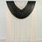 Black sheer curtains draped over white curtains in a room