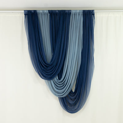 Navy and light blue layered sheer curtains hanging on a rod