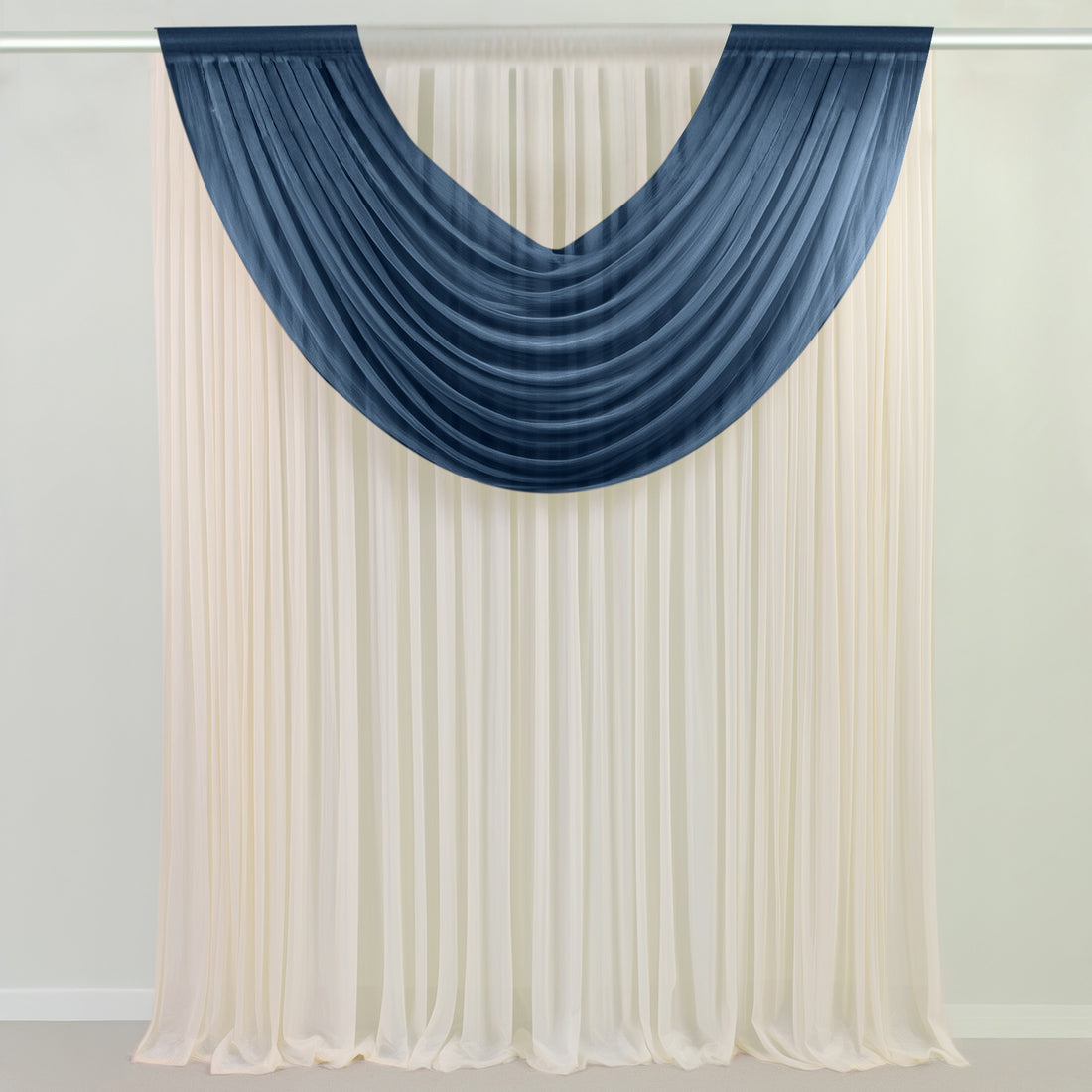 Navy and cream sheer draped curtains on a wall-mounted rod