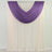 Purple sheer swag curtain over ivory panel on a rod