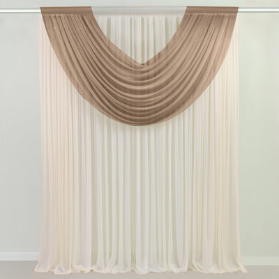 Beige sheer drapes layered over white curtains on a rod