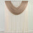 Beige sheer drapes layered over white curtains on a rod