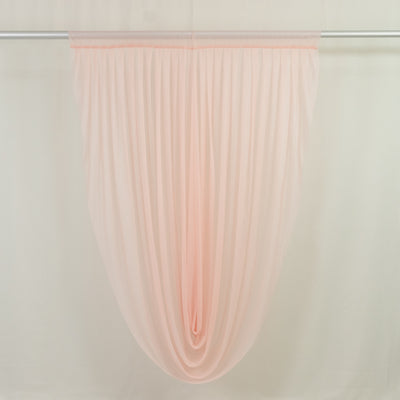 Sheer blush pink window curtain panel on rod