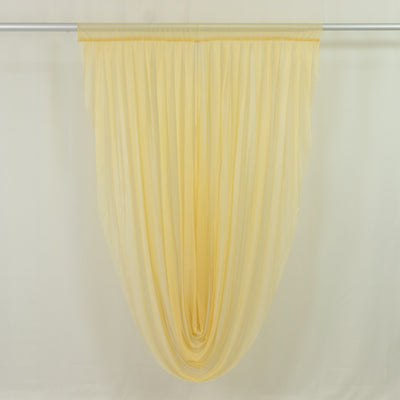 Sheer yellow window curtain panel on rod