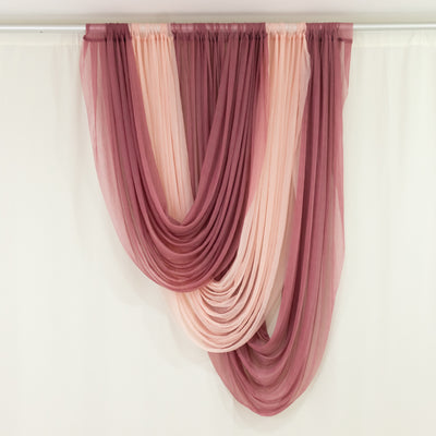Layered pink and blush sheer curtains on rod