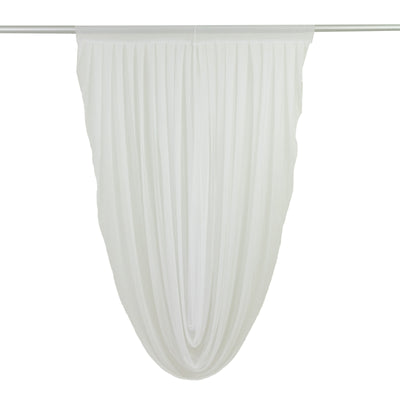 White sheer drapery fabric in a flowing design 