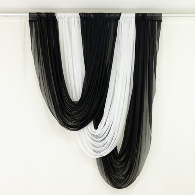 Black and white sheer fabric drapery hanging elegantly. 