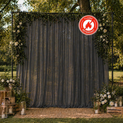 Elegant outdoor wedding arch with floral decor and flame retardant drape