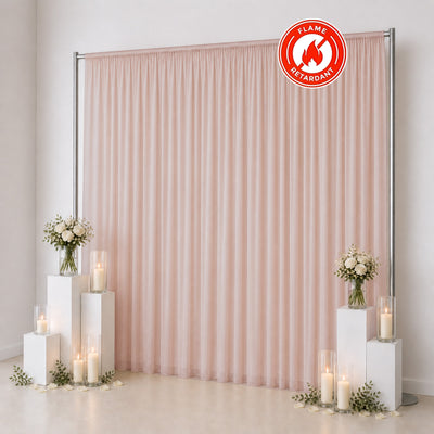 Pastel pink flame retardant curtain backdrop with wedding decor and candles