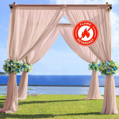 Flame retardant outdoor wedding arch draped with pink fabric and floral accents.