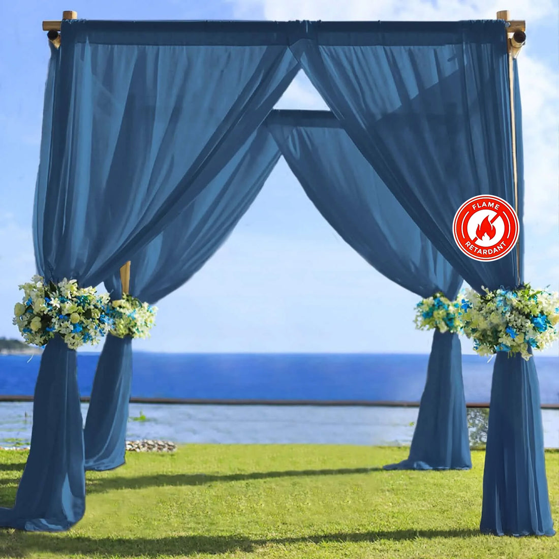 Blue wedding arch with floral arrangements by the seaside.