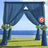 Blue wedding arch with floral arrangements by the seaside.