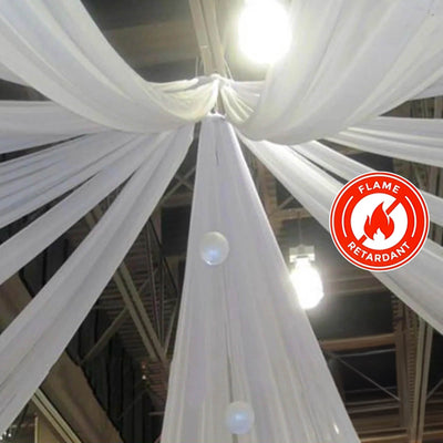 White flame-retardant drapery fabric hanging from ceiling