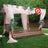 Outdoor wooden gazebo draped with pink fabric and greenery