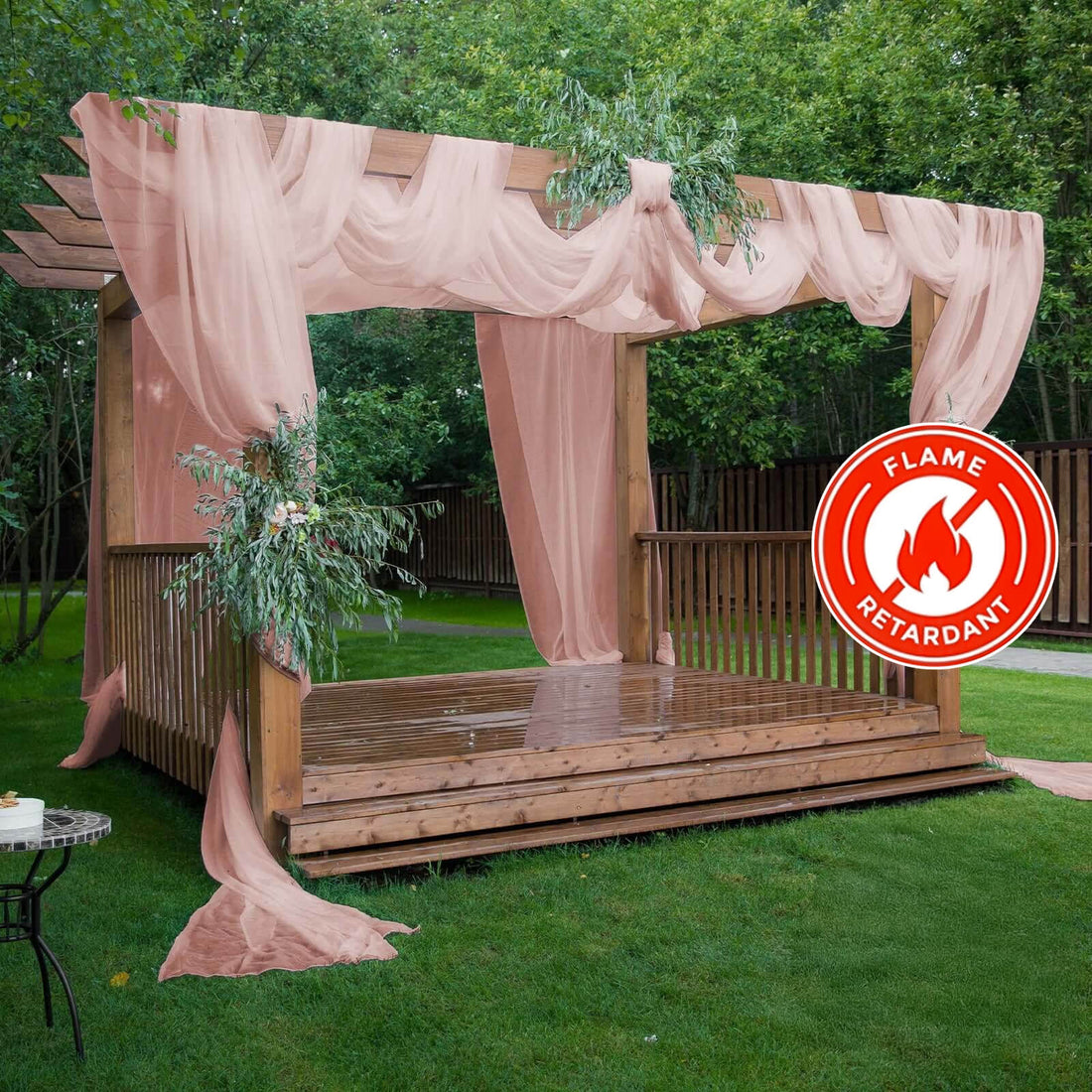 Flame-retardant draped pergola with greenery in a garden setting.