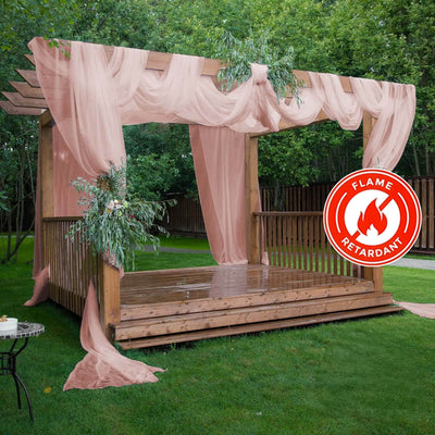 Flame-retardant draped pergola with greenery in a garden setting.