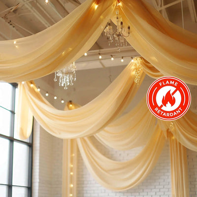 Elegant sheer drapes with chandeliers in a beautifully decorated venue.