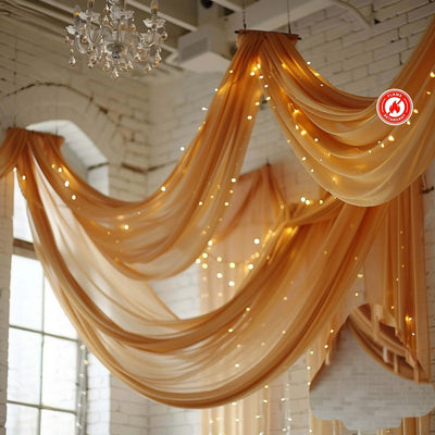 Elegant draped fabric with fairy lights in a bright interior setting.