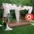 Flame-retardant outdoor wedding pergola with draped fabric and greenery.