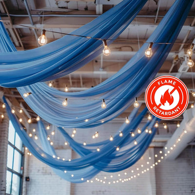 Blue fabric draping with string lights in a decorated space, flame retardant feature.