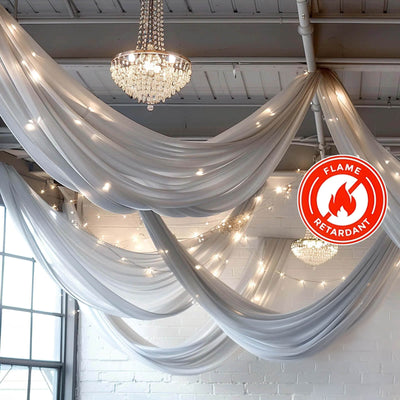 Decorative sheer drapes with lights and a flame retardant label.