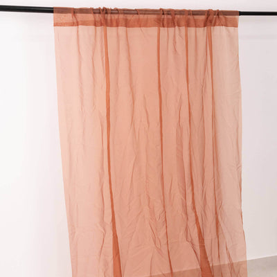Sheer curtain panel in soft peach color with a subtle striped design